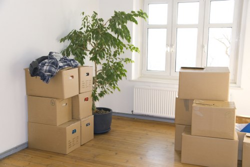 Office equipment, desks, and boxes organised for a commercial relocation